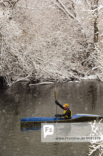 A former US National Team paddler kayaks on a river in Whitefish  MT.