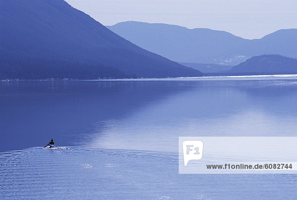 Solo male paddling a kayak on Lake McDonald  Glacier National Park  MT.