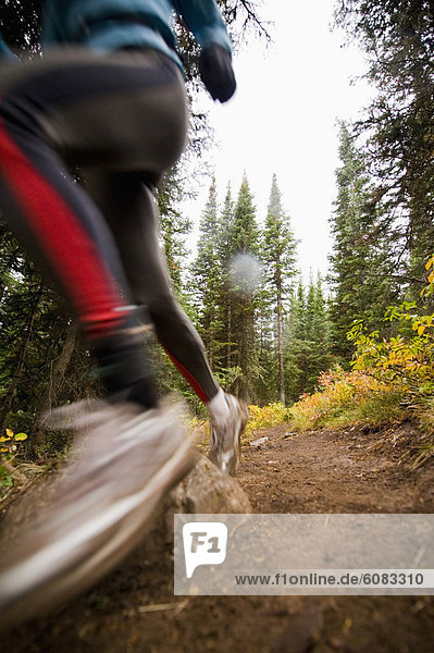 A woman trail running on a cloudy day in Jackson Hole  Wyoming. (motion blur)