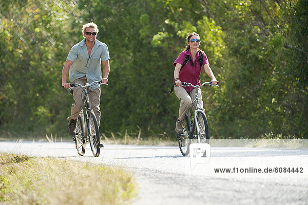 A couple ride bicycles in Everglades National Park  Florida.