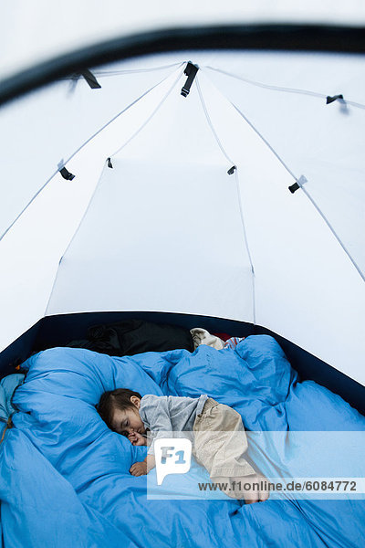 A 14 month baby boy sleeps on a pillow of sleeping bags in a tent at about 11 000 feet in the Maroon Bells in Snowmass Wilderness just outside of Aspen.