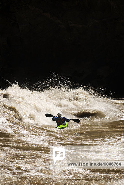 A kayaker encounters big whitewater during a rafting trip in Western China.