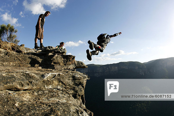 A BASE jumper performs a front flip off a cliff in the Blue Mountains  New South Wales  Australia.