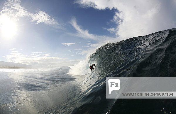 A surfer enters a barrel wave at Maninoa  Upolu  Samoa.