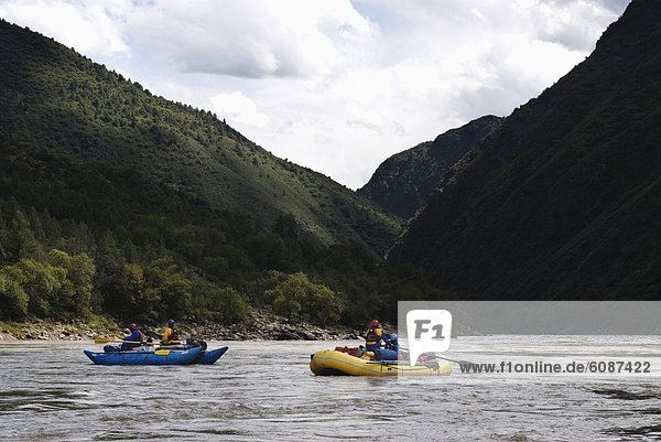 Rubber rafts row downstream during a whitewater rafting trip to Western China.
