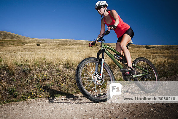 A female mountain biker pedals the trail on Mt. Sentinel  Missoula  Montana.