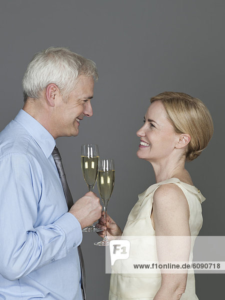 Mature couple drinking sparkling wine  smiling
