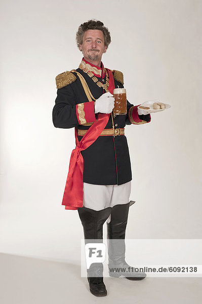 Man as King Ludwig of Bavaria with white sausages and beer mug  portrait