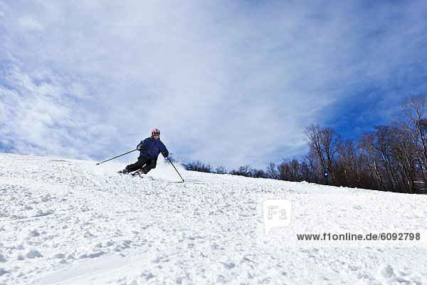 A male downhill skier in New Hampshire.