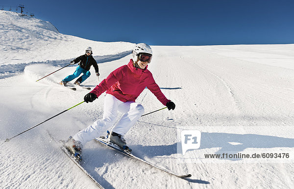 Austria  Salzburg  Young couple skiing on mountain