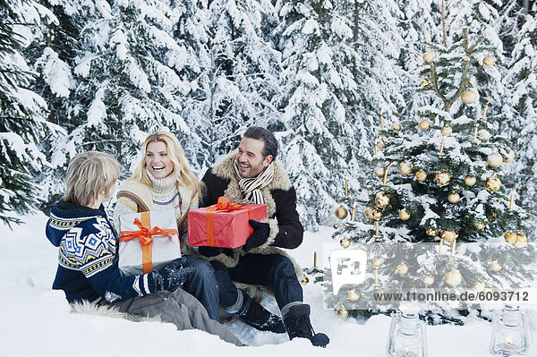 Austria  Salzburg County  Family celebrating christmas in snow