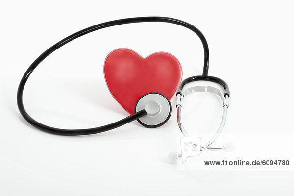 Heart with stethoscope on white background