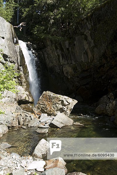 Man jumping off waterfall in Idaho.