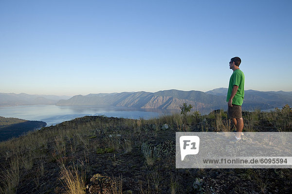 Young man hiking at sunset in Idaho.
