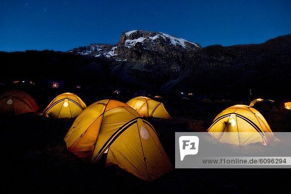 Tents illuminate the night 2 000 ft. below the summit of Mt. Kilimanjaro.