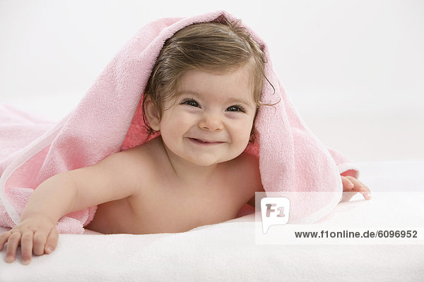 Baby girl with pink blanket  smiling