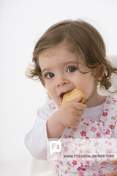 Baby girl eating cookie  close up