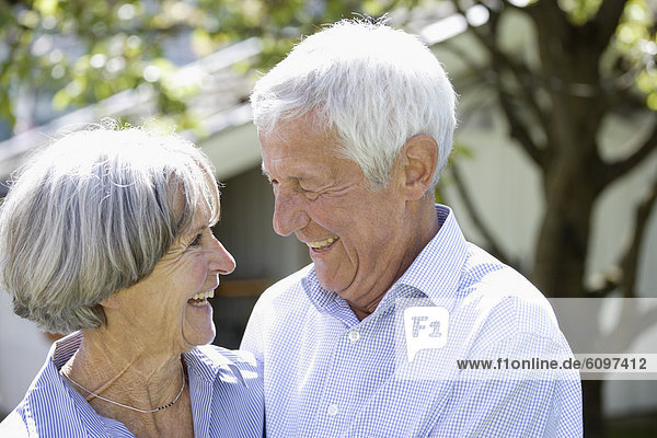 Germany  Bavaria  Senior couple looking at each other  smiling