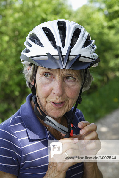 Senior woman with bicycle helmet  close up