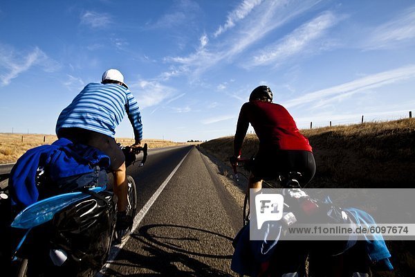 Two male cyclists ride Highway 65 outside of Porterville  California.