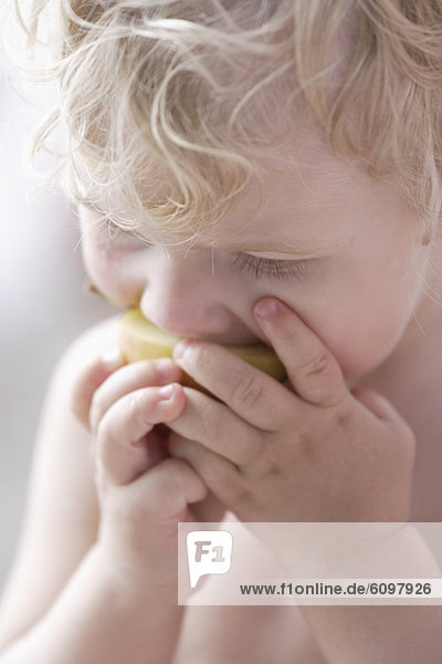 Boy eating apple  close up