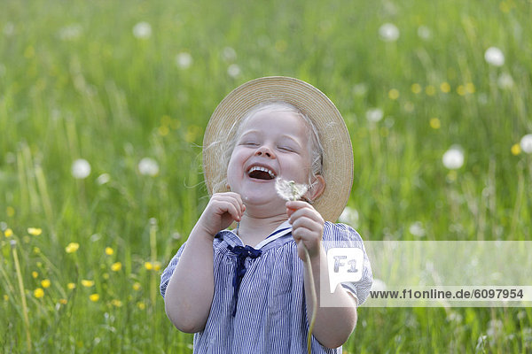 Girl with dandelion seed  smiling