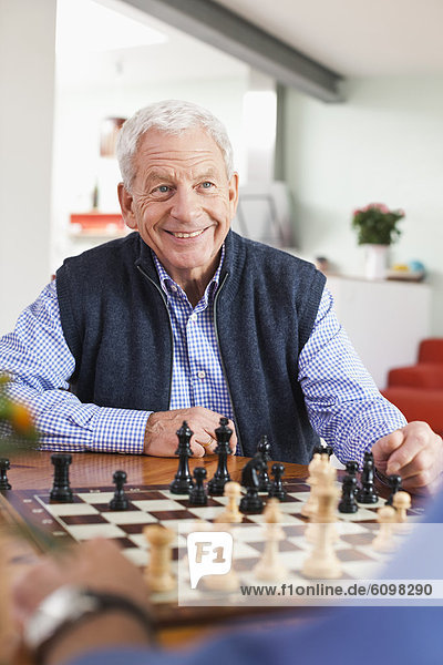 Senior men playing chess game