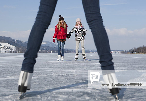 Österreich  Teenagermädchen auf Eisbahn stehend