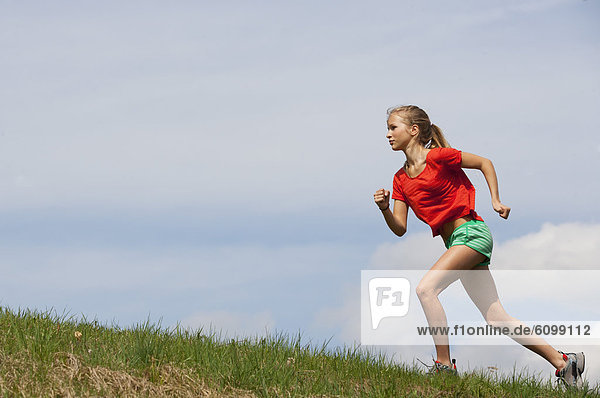 Österreich  Teenagermädchen auf Rasen laufend