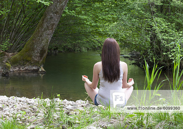 Austria  Young woman doing meditation