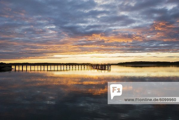 A silhouette of a pier at sunset on the Intracoastal Waterway on Hilton Head Island  SC.