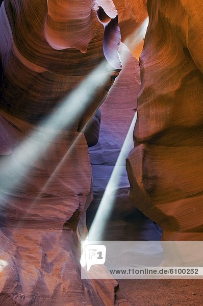 Beams of light penetrate Lower Antelope Canyon located outside of Page  AZ.