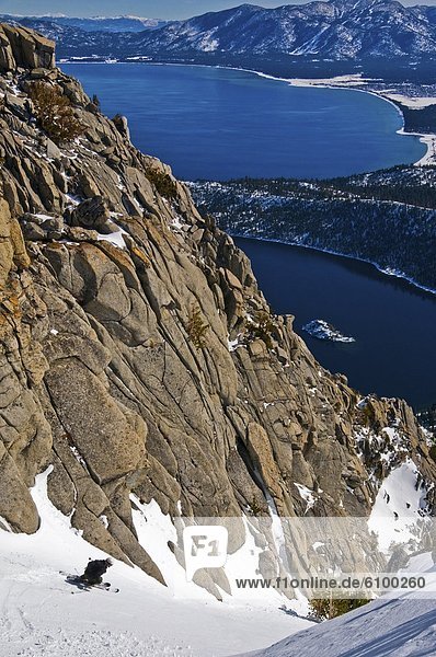 A skier descends Emerald Chute high above Emerald Bay and Lake Tahoe in the winter  CA.