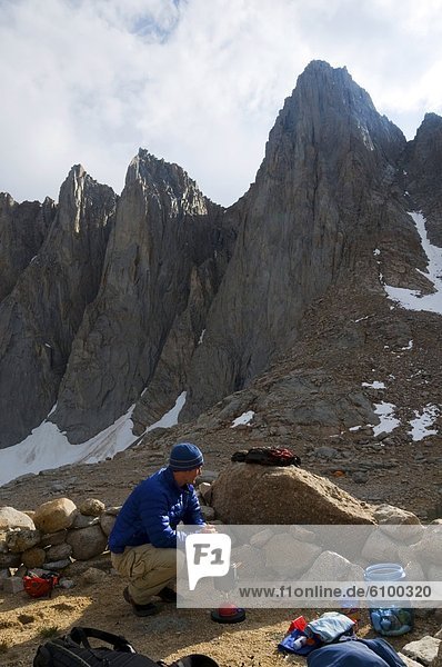A man boils some water at camp below Mount Whitney in the Eastern Sierra  CA.