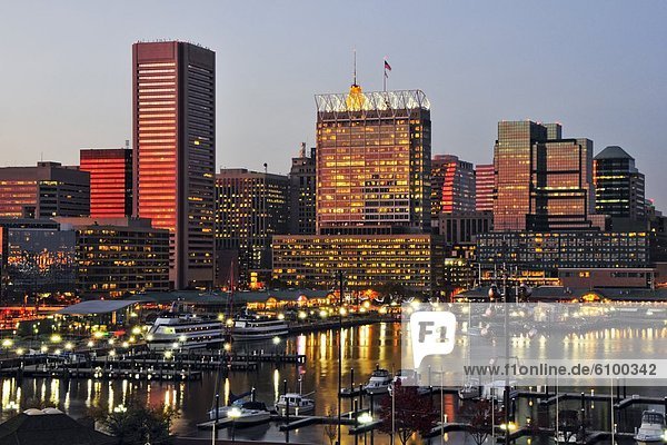 The sunset reflects off the windows of the Baltimore city skyline at dusk  Maryland.