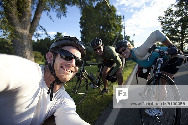 Three cyclists smile for a portrait during a bike ride in Monmouth  Maine.