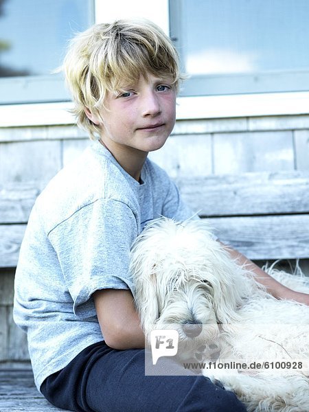 boy and his dog pose for a picture
