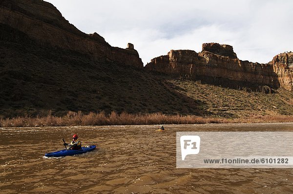 Kayakers paddle their boats downstream on the Salt River which winds through Arizona's Salt River Wilderness Area.