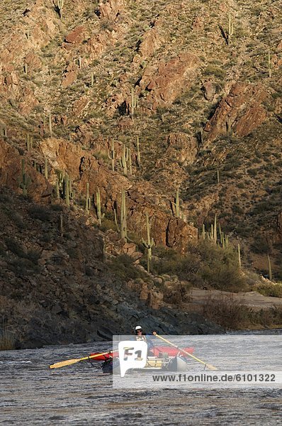 A whitewater rafters rows his boat downstream on the Salt River  AZ.