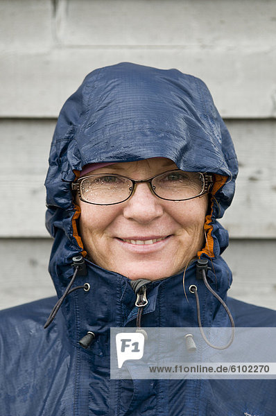 Woman smiling with wet glasses in the rain  Japan.