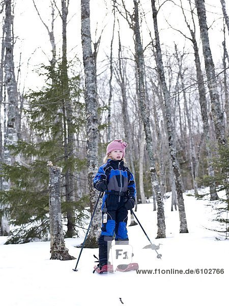 young girl snowshoeing
