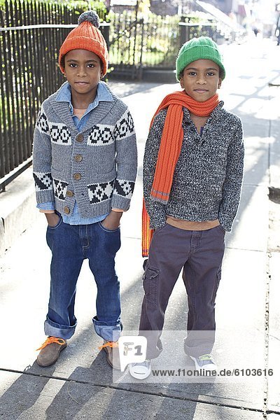 Young twin boys posing for a portrait in Harlem  New York.