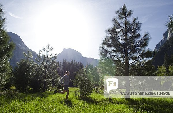 A young woman enjoys an early morning run in Yosemite National Park  California.