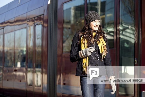 Woman using streetcar in city.