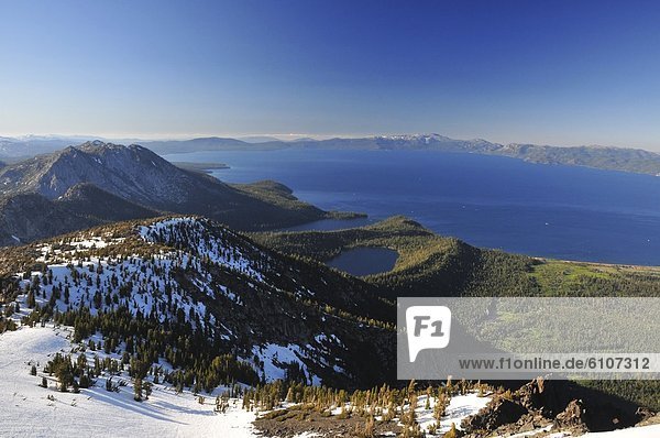 A view of Lake Tahoe from the summit of Mount Tallac with snow still lingering in the summer  California.
