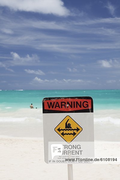 An image of a strong current sign near the shore at Bellows Beach Park in Waimanalo  Hawaii.