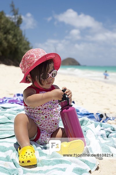 A baby hanging out on the sand at the beach in Waimanalo  Hawaii.