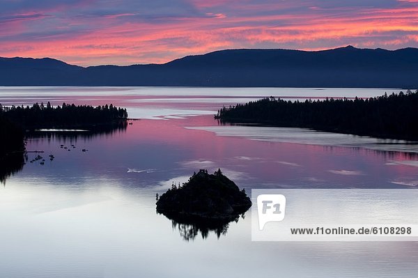 A silhouette of Fannette Island in Emerarld Bay during a beautiful sunrise in Lake Tahoe  CA.