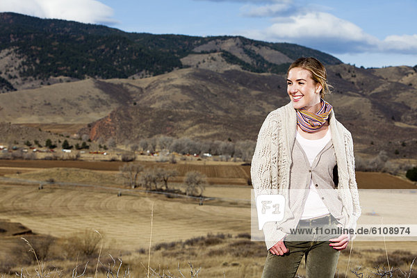 A young woman poses in layered outdoor clothing in Fort Collins  Colorado.