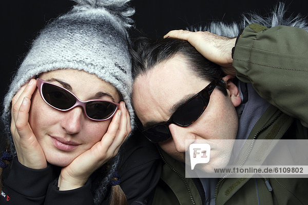 Joyful couple wearing sunglasses.